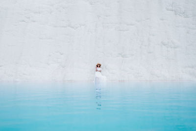 Young woman by travertine pool at pamukkale