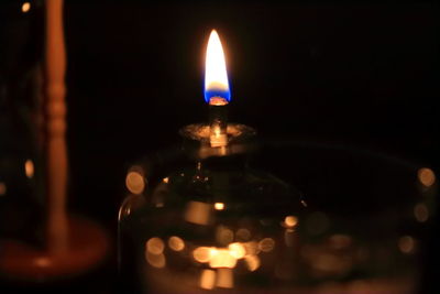 Close-up of lit candle in dark room