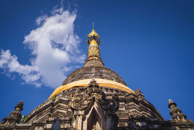 Low angle view of temple building against blue sky