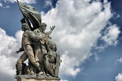 Low angle view of statue against cloudy sky