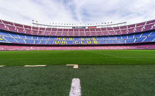 View of soccer field against cloudy sky