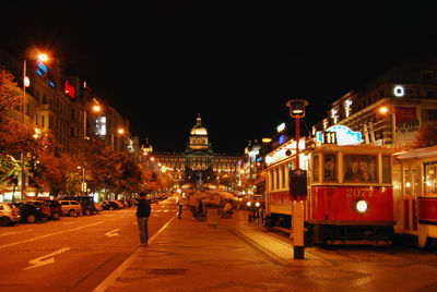 Illuminated city street and buildings at night