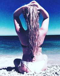 Rear view of woman standing on beach