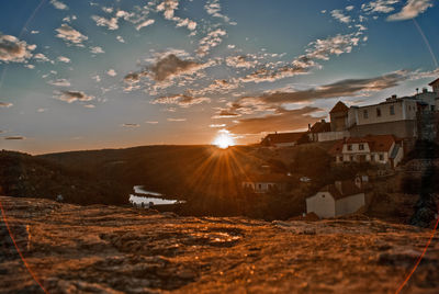 Scenic view of residential buildings against sky during sunset