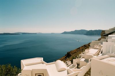 High angle view of sea and buildings against clear sky