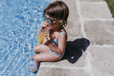 High angle view of girl playing in swimming pool