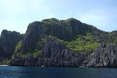 Scenic view of sea and mountains against sky