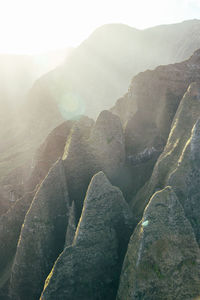 View from helicopter of morning sun on the jagged rocks of the na pali coast on kauai, hawaii.