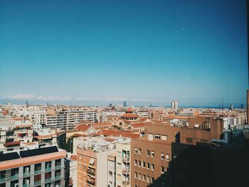 Cityscape against clear blue sky