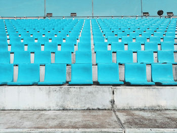 Row of blue seats against blue sky 