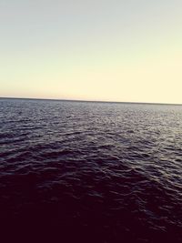 Scenic view of sea against clear sky during sunset