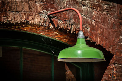 Close-up of electric lamp against wall