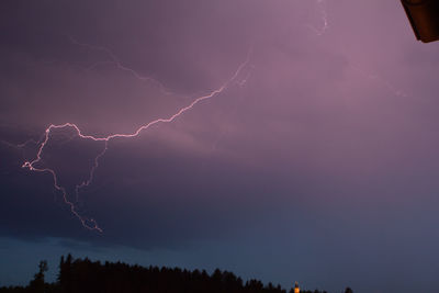 Low angle view of lightning against sky at night