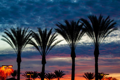 Silhouette palm trees against sky during sunset