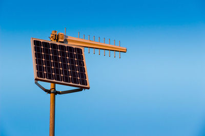 Low angle view of street light against blue sky