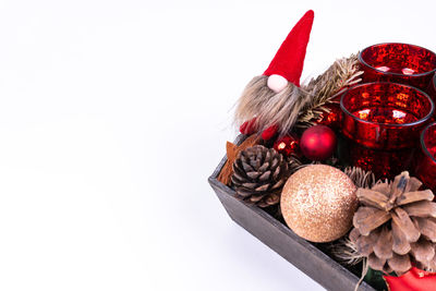 Close-up of christmas decorations over white background