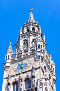 Spire with horology of munich rathaus , bavaria germany . top of new town hall in munich