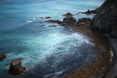 High angle view of rocks at sea shore