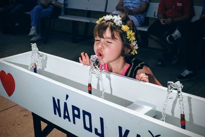 Close-up of girl drinking from fountain