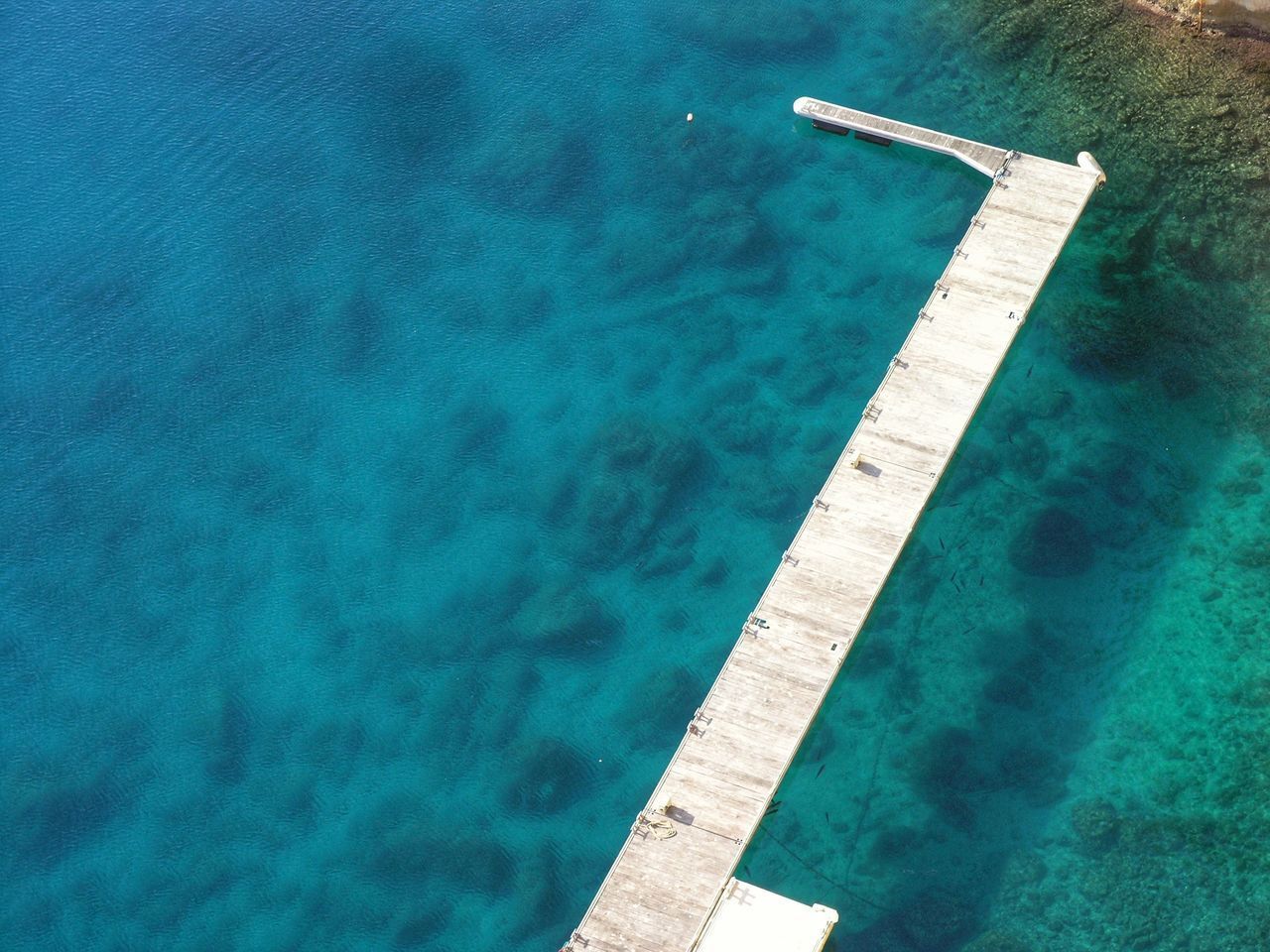 HIGH ANGLE VIEW OF SWIMMING POOL AT SEA