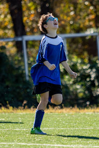 Full length of boy celebrating after scoring a goal in a soccer game