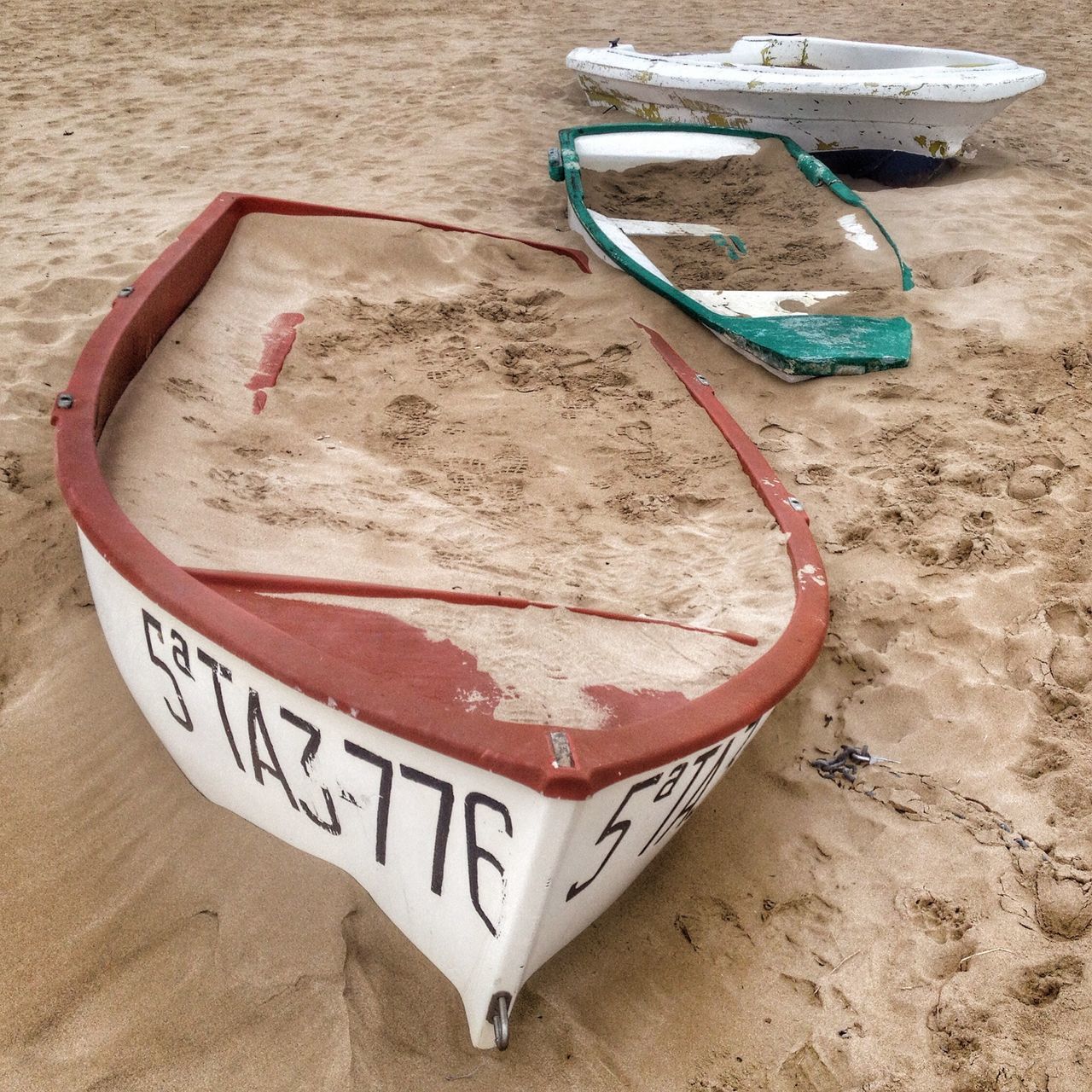 high angle view, text, transportation, moored, beach, sand, nautical vessel, abandoned, boat, communication, absence, day, western script, no people, outdoors, still life, wood - material, empty, mode of transport, red