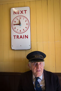 Portrait of man standing against wall