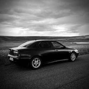 Vintage car against cloudy sky