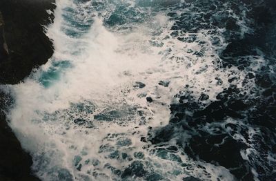 High angle view of waves splashing on shore