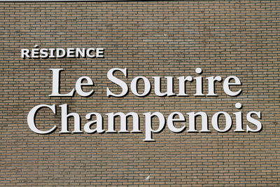 Close-up of text on brick wall