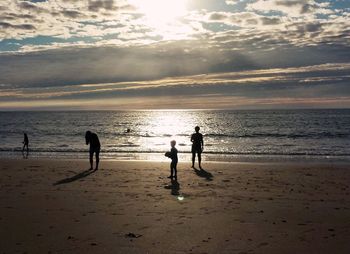 People on beach at sunset