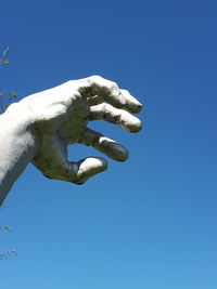 Low angle view of statue against clear blue sky