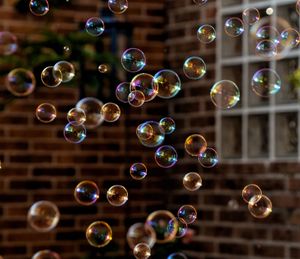 Close-up of bubbles against brick wall