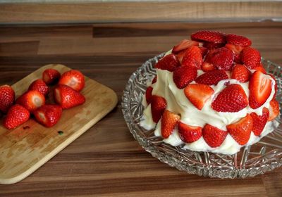 High angle view of strawberry birthday cake on table