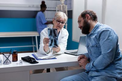 Female doctor discussing with patient at clinic