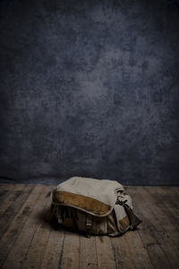 High angle view of old wooden table against wall