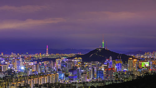 High angle view of city lit up at night