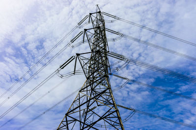 Low angle view of electricity pylon against sky