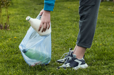 Low section of man holding umbrella