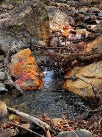 High angle view of stream flowing through rocks