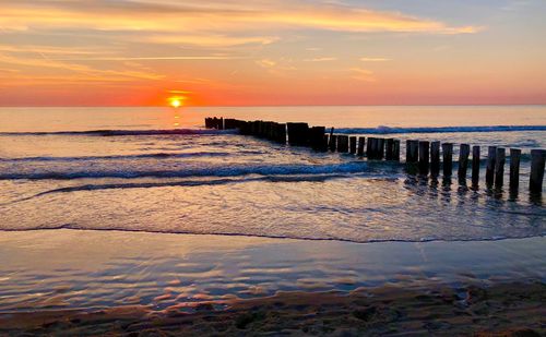 Scenic view of sea against sky during sunset