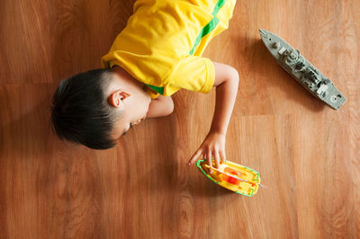 High angle view of woman holding wood at home