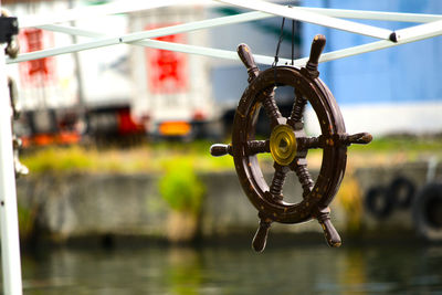 Close-up of wheel by river