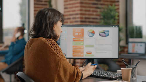 Young woman using laptop at office