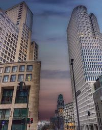 Low angle view of modern buildings against sky at dusk