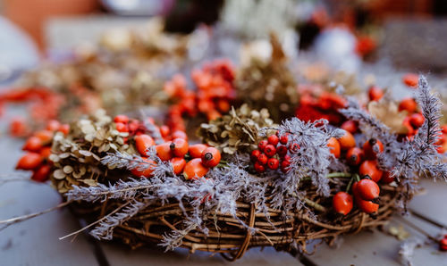 Floral autumn door wreath made from natural materials colorful rosehip berries, rowan, dry flowers