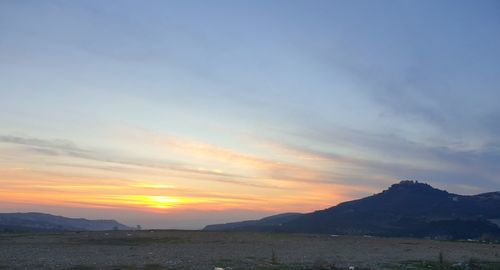 Scenic view of mountains against sky during sunset