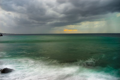 Scenic view of sea against cloudy sky