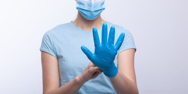 Low section of person standing against white background