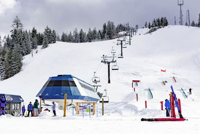 Panoramic view of people skiing on snowcapped mountain